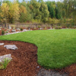 A garden with grass and rocks in the middle of it